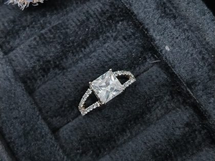 princess cut engagement ring, split shank diamond ring, square cut solitaire, pavé band ring, women's cubic zirconia ring, white gold plated ring, affordable bridal jewelry, modern princess cut ring, split row pavé setting, elegant statement ring