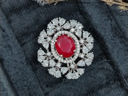 ruby statement ring, oval ruby and diamond ring, pear cut cluster jewelry, red stone cocktail ring, luxury floral ring, large gemstone ring, dramatic cluster ring, vintage style ruby ring, high-end fashion jewelry, bespoke ruby design