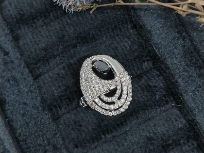 black stone statement ring, oval black onyx ring, modern cocktail ring women, asymmetrical diamond ring, unique curve design ring, abstract jewelry design, black and white fine jewelry, contemporary black stone ring, fashion forward statement ring, buy unique cocktail rings